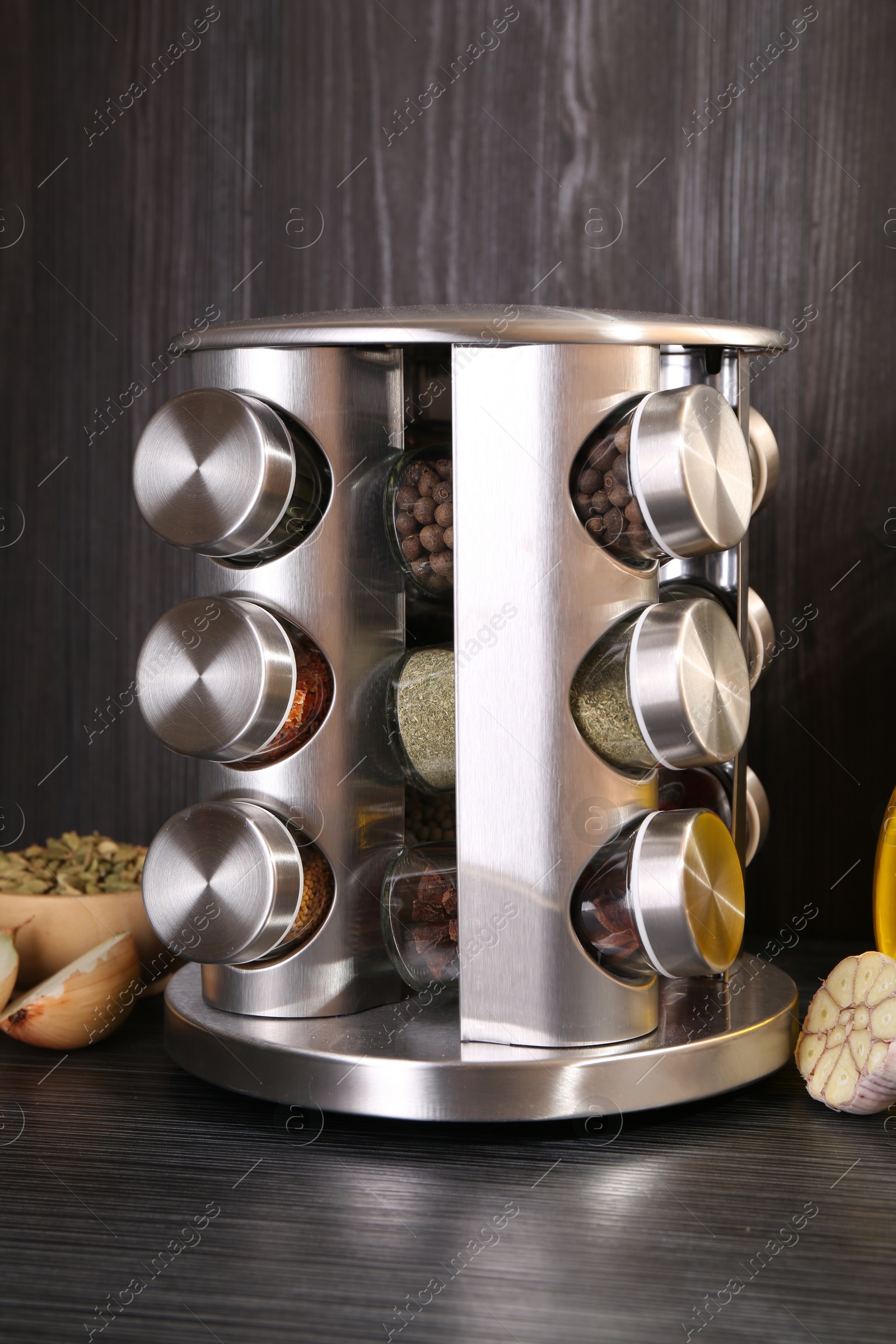 Photo of Set of jars with different spices on grey wooden table