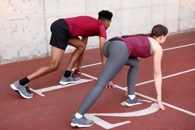 Photo of Couple in starting position for run at stadium