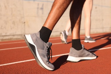 Photo of Runners walking at stadium, closeup. Healthy lifestyle
