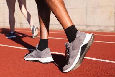 Photo of Runners walking at stadium, closeup. Healthy lifestyle