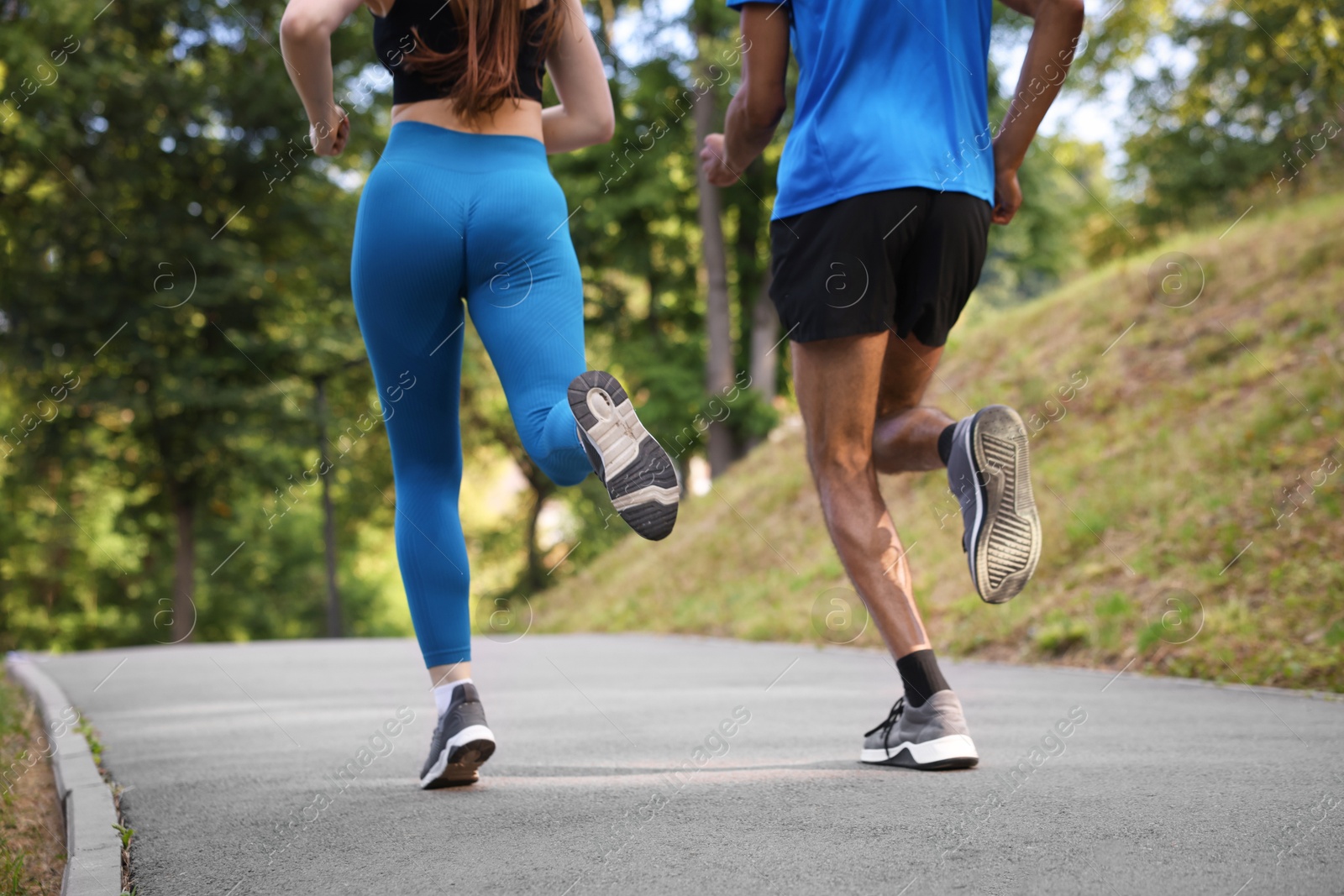Couple in sportswear running in park, closeup Photo of Couple in sportswear running in park, closeup