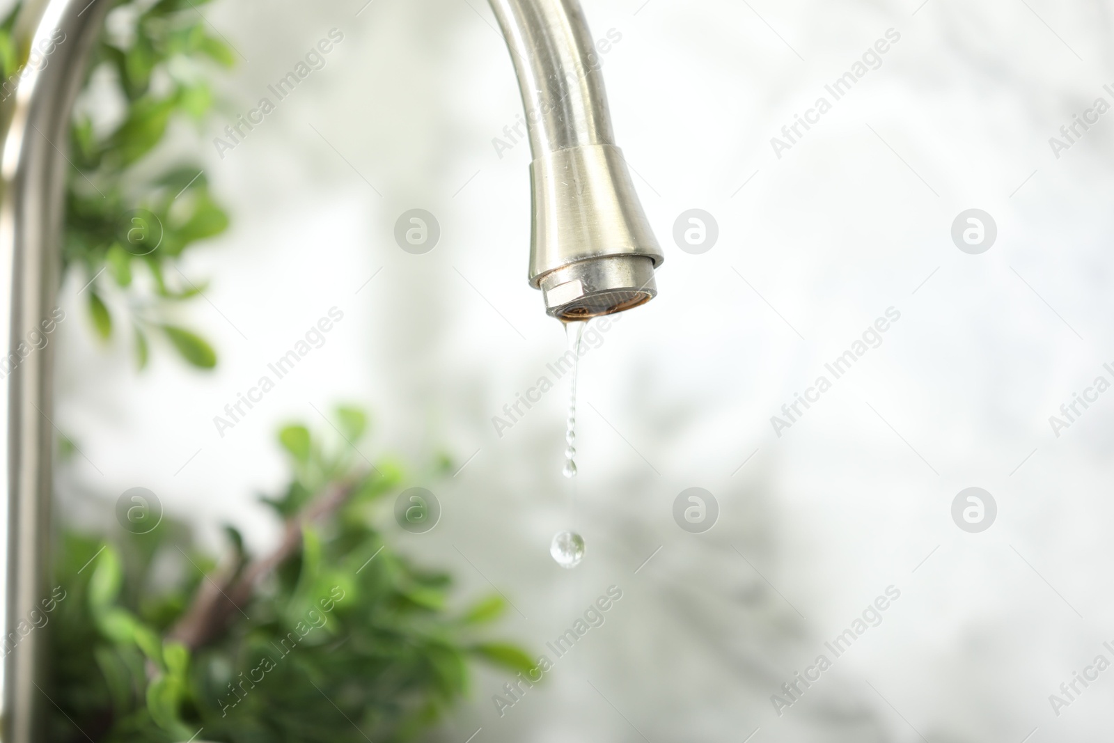 Photo of Save water concept. Water dripping from tap indoors, closeup. Space for text