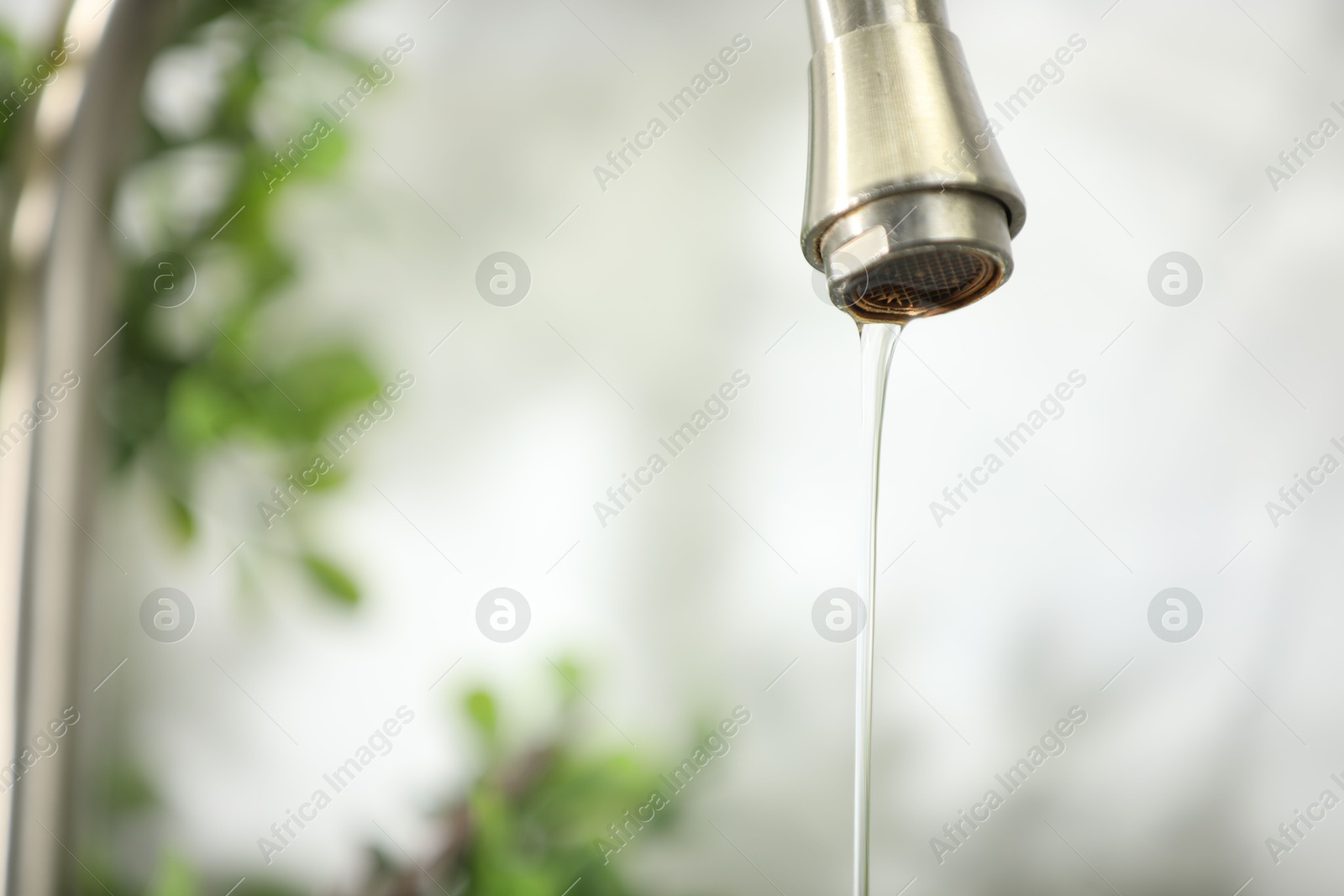 Photo of Save water concept. Water dripping from tap indoors, closeup. Space for text