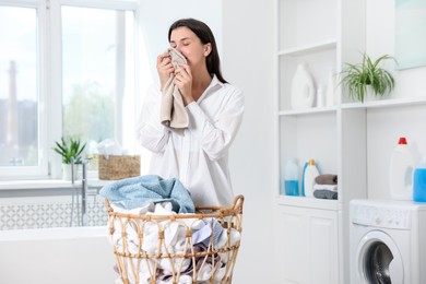 Photo of Woman with clean laundry indoors, space for text