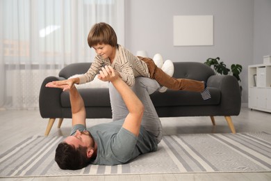 Photo of Father and son having fun at home