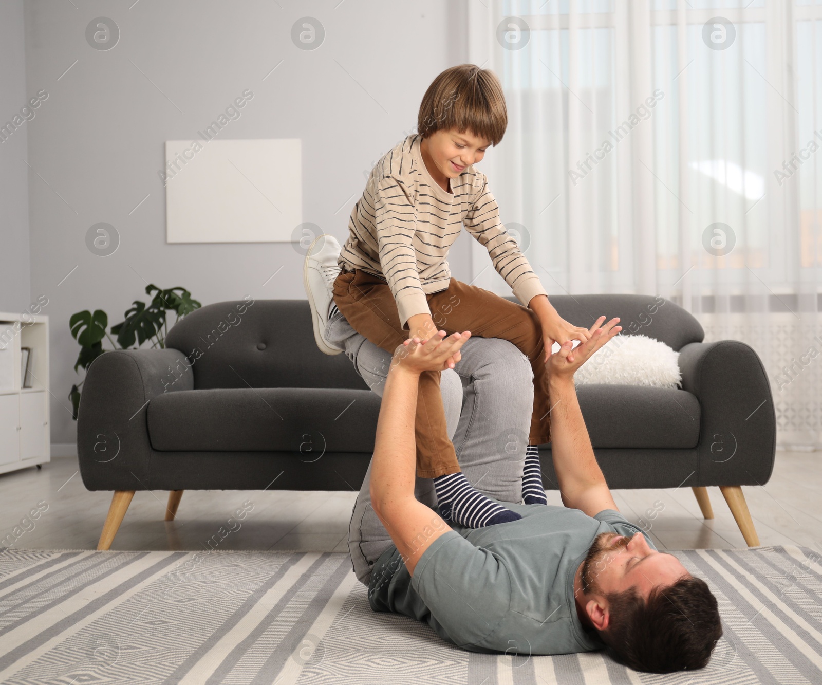 Photo of Father and son having fun at home
