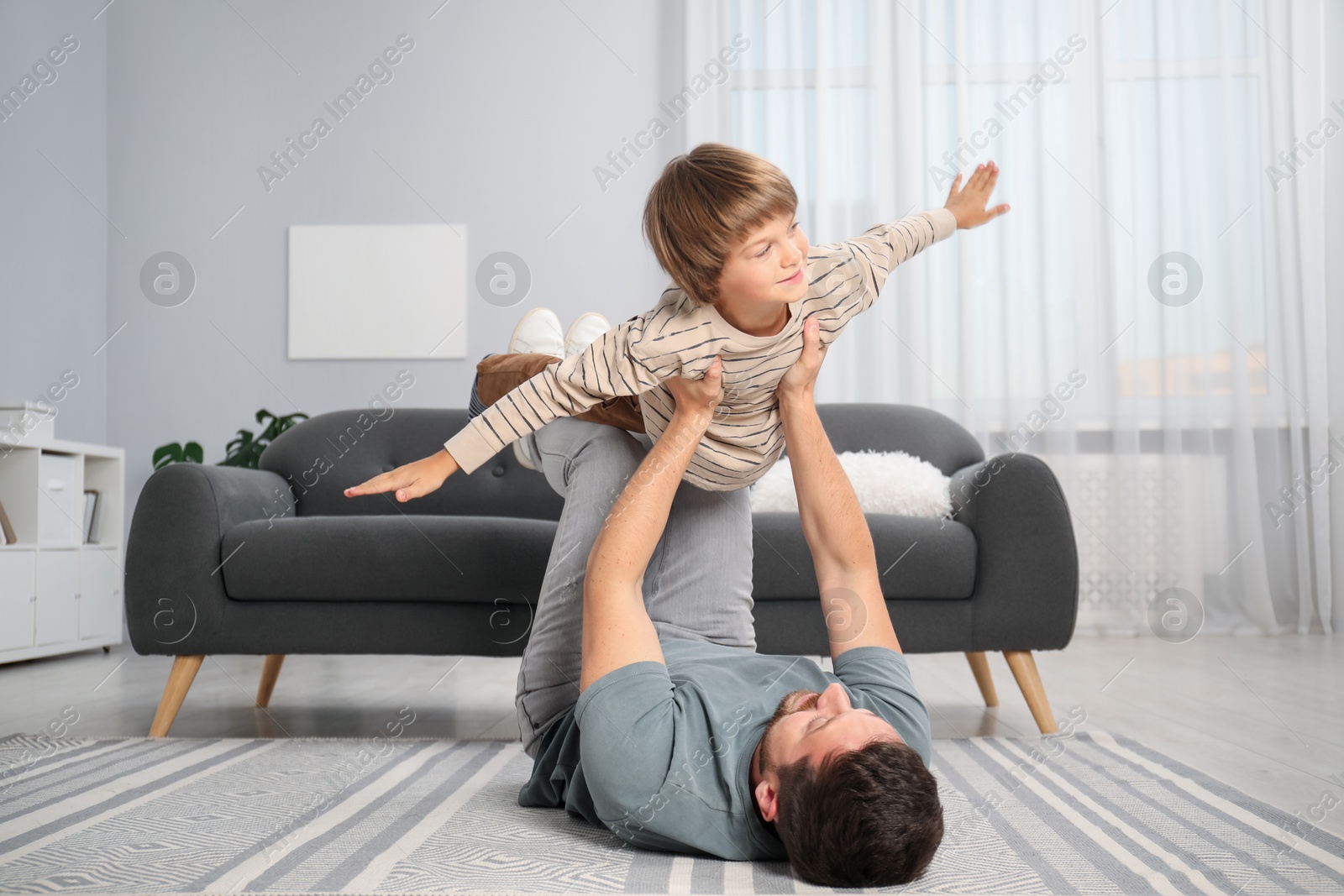 Photo of Father and son having fun at home