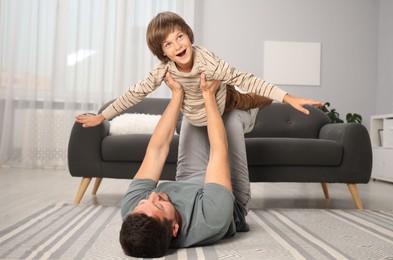 Photo of Father and son having fun at home