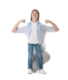 Photo of Son pretending to have big biceps with his father hiding behind him on white background