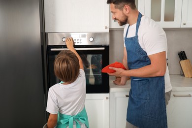 Photo of Father and son baking together in kitchen