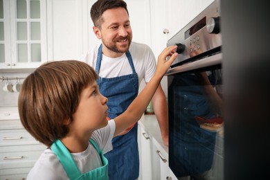 Photo of Father and son baking together in kitchen
