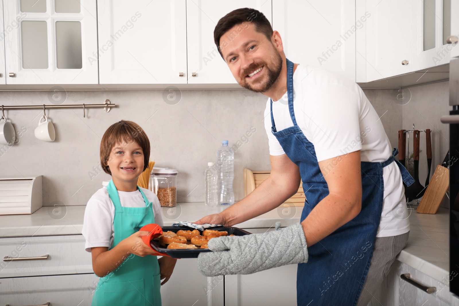 Photo of Father and son baking pastries in kitchen