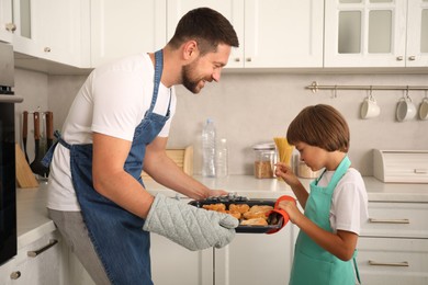Photo of Father and son baking pastries in kitchen