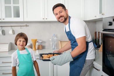 Photo of Father and son baking pastries in kitchen