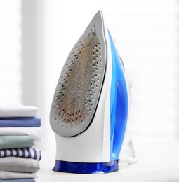 Image of Clothes iron soleplate with burnt residue and scale indoors, closeup