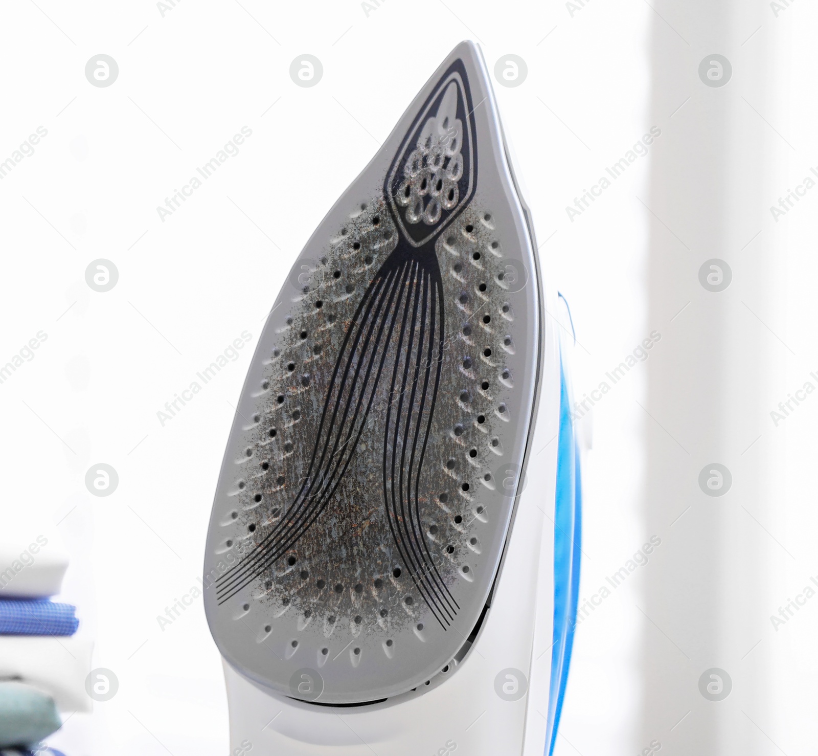 Clothes iron soleplate with burnt residue and scale indoors, closeup Image of Clothes iron soleplate with burnt residue and scale indoors, closeup