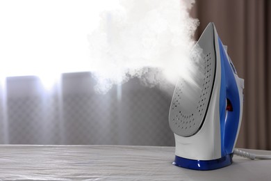 Image of Steam coming out of clothes iron indoors