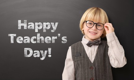 Image of Happy Teacher's Day. Cute little boy with eyeglasses near black board
