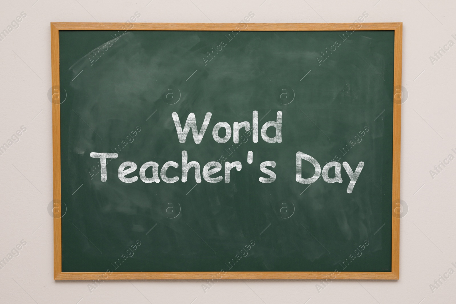 Image of Happy Teacher's Day greeting card. Text on green chalkboard