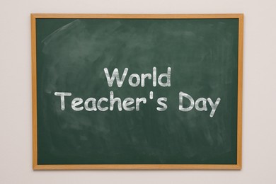 Image of Happy Teacher's Day greeting card. Text on green chalkboard