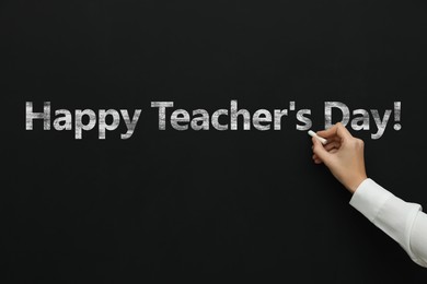 Image of Happy Teacher's Day greeting card. Woman writing text on blackboard, closeup