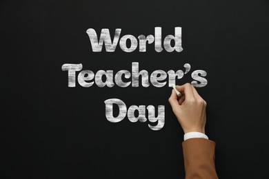 Image of Happy Teacher's Day greeting card. Woman writing text on blackboard, closeup
