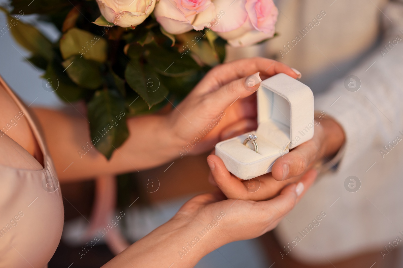 Man with engagement ring and bouquet of flowers making marriage proposal to his girlfriend on blurred background, closeup Photo of Man with engagement ring and bouquet of flowers making marriage proposal to his girlfriend on blurred background, closeup