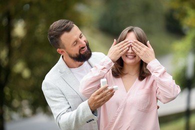 Photo of Man with engagement ring making marriage proposal to his girlfriend outdoors