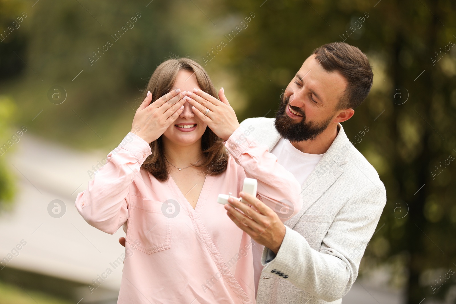 Photo of Man with engagement ring making marriage proposal to his girlfriend outdoors