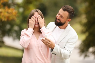 Photo of Man with engagement ring making marriage proposal to his girlfriend outdoors