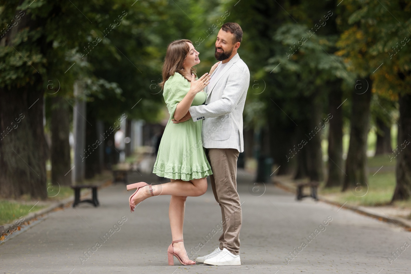 Making marriage proposal. Woman showing engagement ring and hugging her fiance outdoors Photo of Making marriage proposal. Woman showing engagement ring and hugging her fiance outdoors