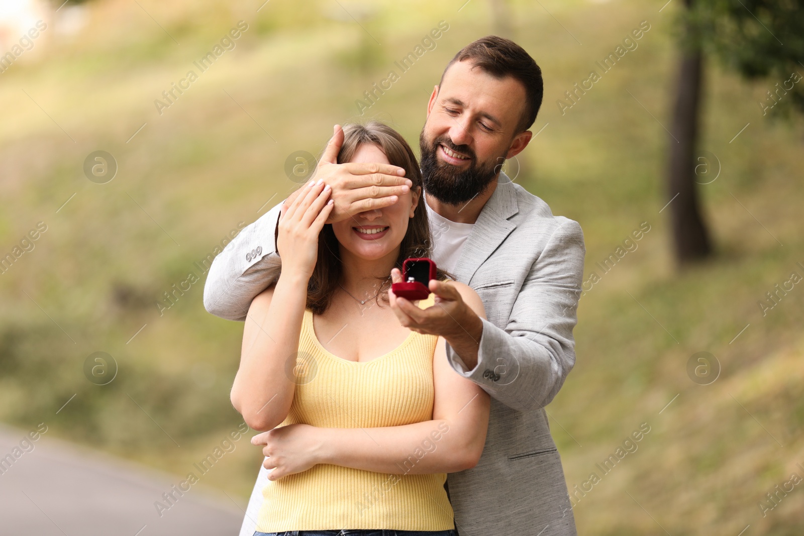 Photo of Man with engagement ring making marriage proposal to his girlfriend outdoors