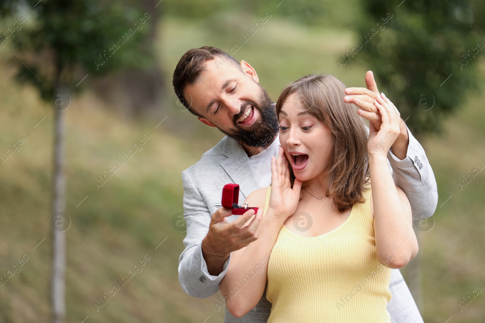 Man with engagement ring making marriage proposal to his girlfriend outdoors, space for text Photo of Man with engagement ring making marriage proposal to his girlfriend outdoors, space for text