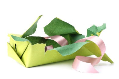 Photo of Torn wrapping paper and ribbon isolated on white