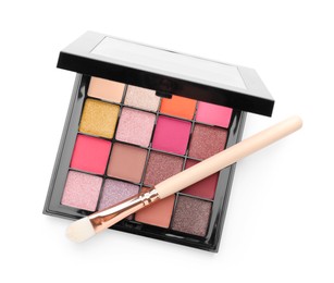 Photo of Beautiful eyeshadow palette with brush isolated on white, top view