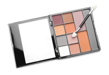 Photo of Beautiful eyeshadow palette with applicator isolated on white, top view