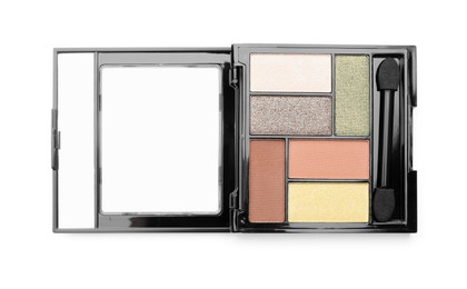 Photo of Beautiful eyeshadow palette with applicator isolated on white, top view