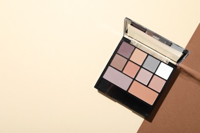 Photo of Beautiful eyeshadow palette on color background, top view. Space for text