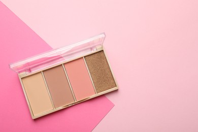 Photo of Beautiful contouring palette on pink background, top view. Space for text