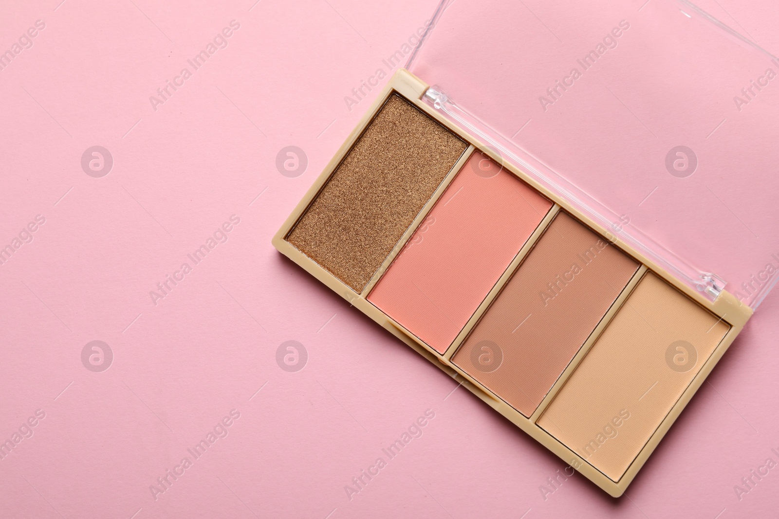 Beautiful contouring palette on light pink background, top view. Space for text Photo of Beautiful contouring palette on light pink background, top view. Space for text