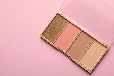 Photo of Beautiful contouring palette on light pink background, top view. Space for text