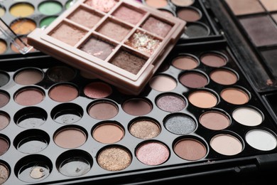Photo of Different used eyeshadow palettes as background, closeup