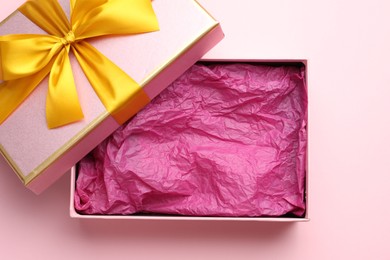 Photo of Open gift box with beautiful lid on pink background, top view