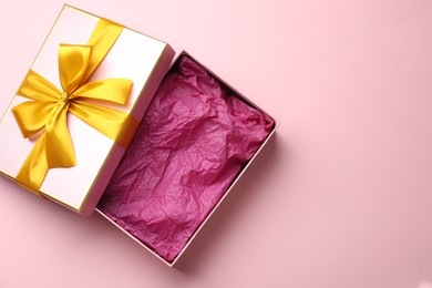 Photo of Open gift box with beautiful lid on pink background, top view. Space for text