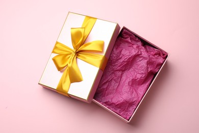 Photo of Open gift box with beautiful lid on pink background, top view