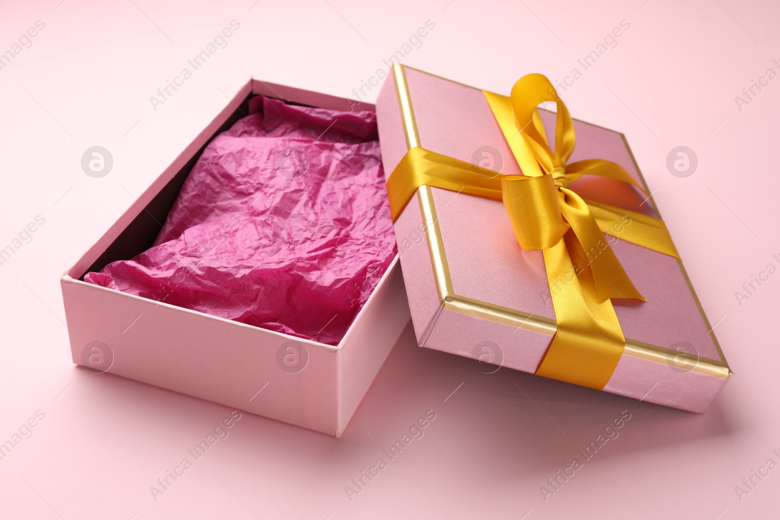 Photo of Open gift box with beautiful lid on pink background