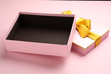 Photo of Open gift box with beautiful lid on pink background