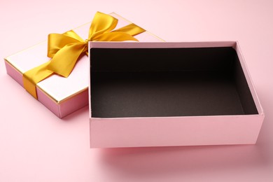 Photo of Open gift box with beautiful lid on pink background