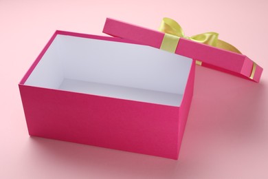 Photo of Open gift box with beautiful lid on pink background
