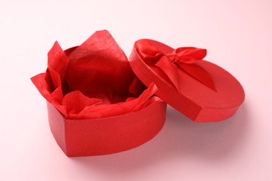 Photo of Heart-shaped gift box with beautiful lid on pink background